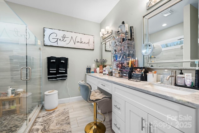 bathroom with vanity and an enclosed shower