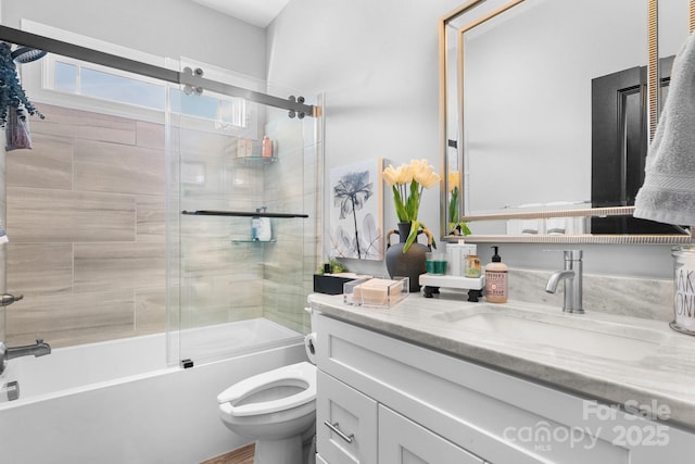 full bathroom with vanity, toilet, and combined bath / shower with glass door