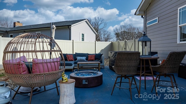 view of patio / terrace featuring an outdoor living space with a fire pit