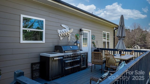 wooden deck with a grill