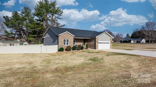 view of front of home featuring a garage and a front lawn