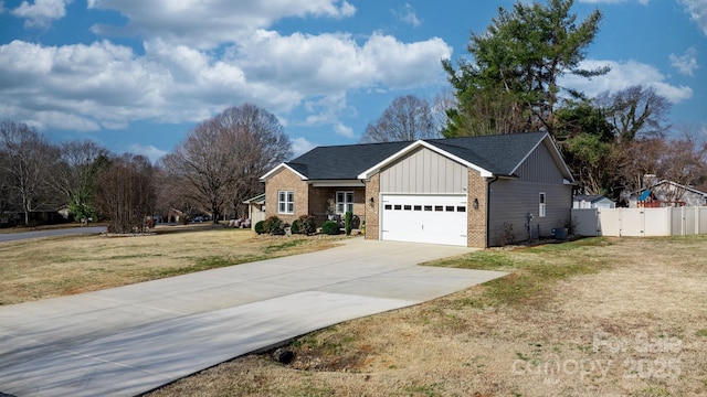 view of front of property featuring a garage and a front yard