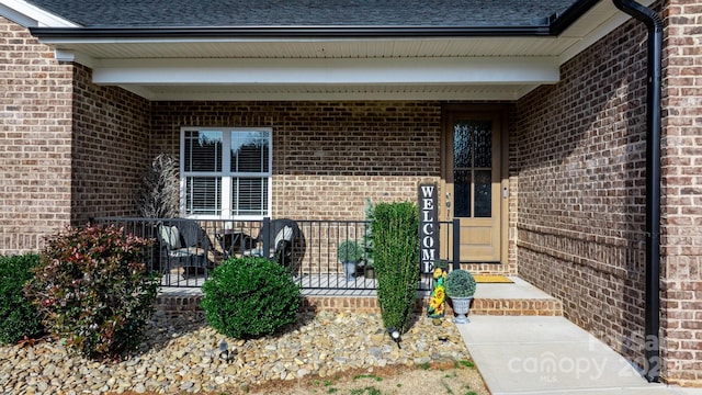 view of exterior entry with covered porch