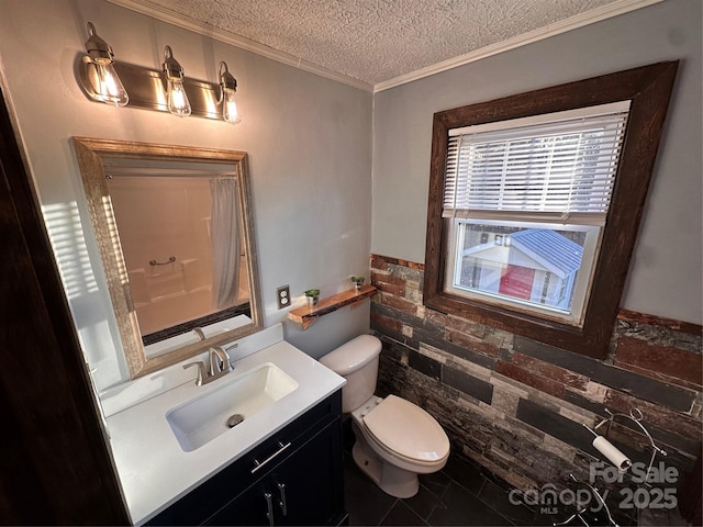 bathroom featuring vanity, crown molding, toilet, and a textured ceiling