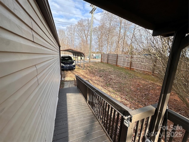 wooden terrace featuring a carport