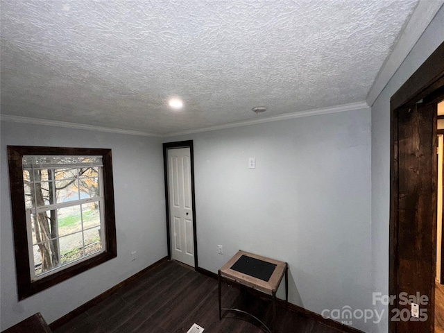 empty room with crown molding, dark hardwood / wood-style flooring, and a textured ceiling