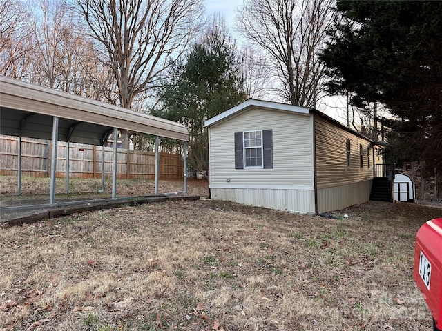 view of property exterior featuring a carport and a shed