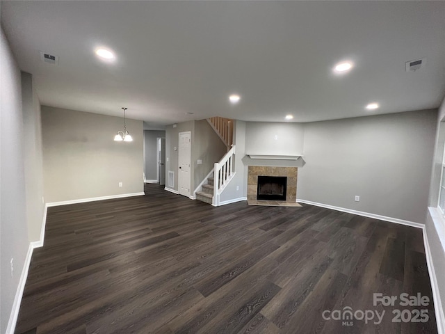 9103 Exbury Ct, Charlotte, NC 28269 - unfurnished living room with dark hardwood / wood-style flooring and a tile fireplace