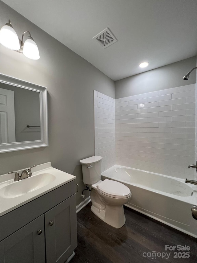9103 Exbury Ct, Charlotte, NC 28269 - full bathroom with tiled shower / bath combo, wood-type flooring, vanity, and toilet