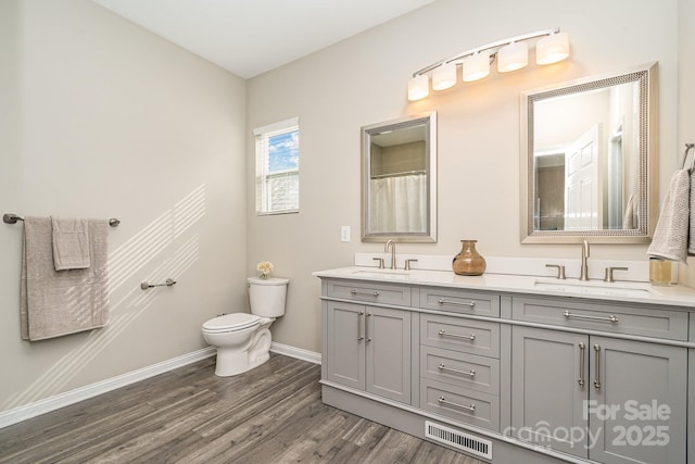 bathroom with vanity, hardwood / wood-style floors, and toilet