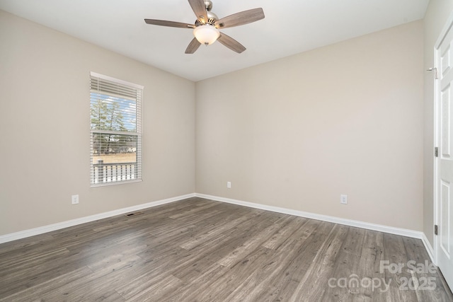 spare room featuring ceiling fan and dark hardwood / wood-style flooring