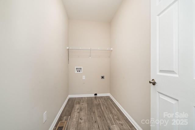 clothes washing area with hardwood / wood-style floors, hookup for a washing machine, and hookup for an electric dryer