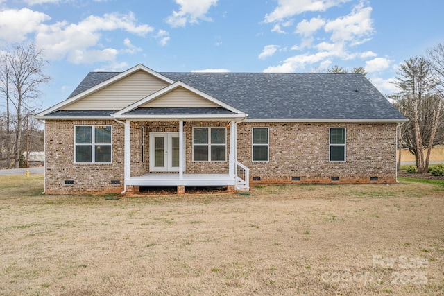 rear view of house with a yard and french doors