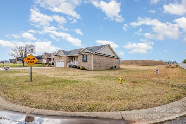 ranch-style house with a garage and a front lawn