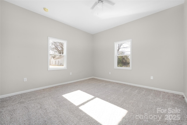 empty room featuring ceiling fan, carpet flooring, and baseboards