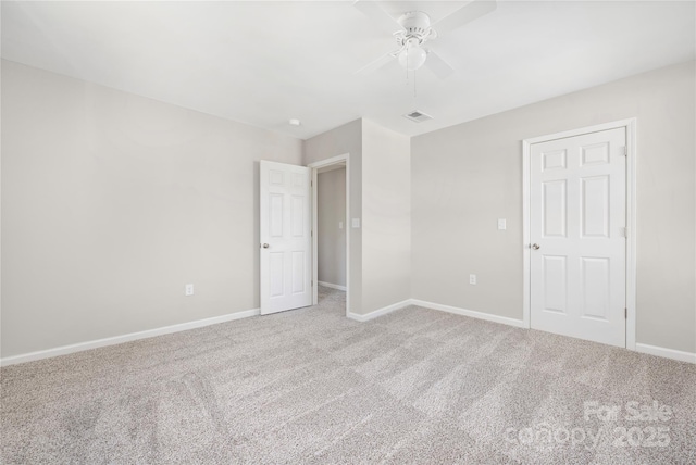 unfurnished bedroom featuring carpet floors, baseboards, and visible vents