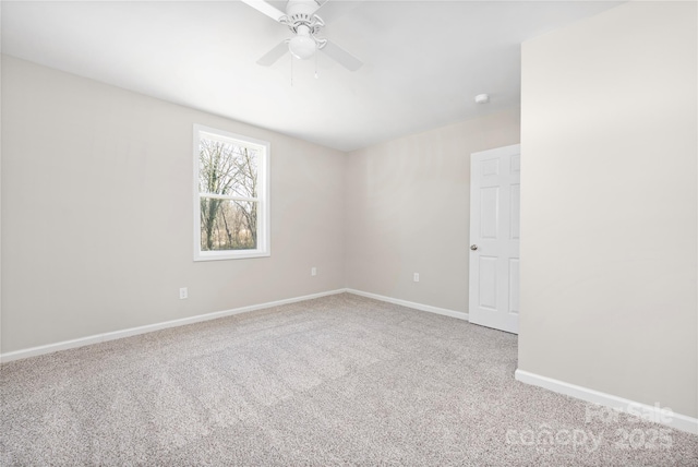 empty room with carpet, baseboards, and a ceiling fan