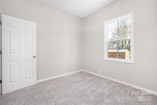 carpeted spare room with baseboards