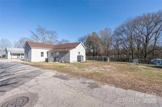 rear view of property featuring fence and central air condition unit