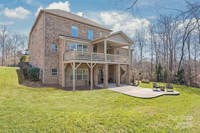 rear view of property featuring a patio, a deck, ceiling fan, and a lawn