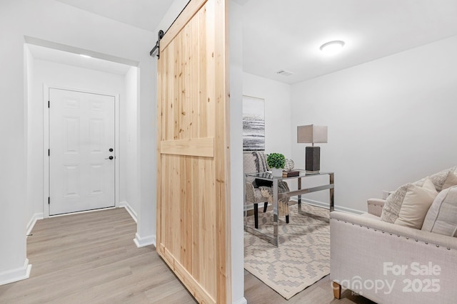 interior space featuring a barn door and light wood-type flooring