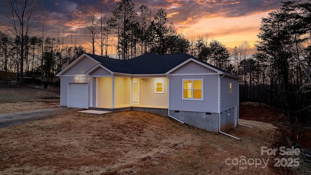 ranch-style home with crawl space, driveway, and an attached garage