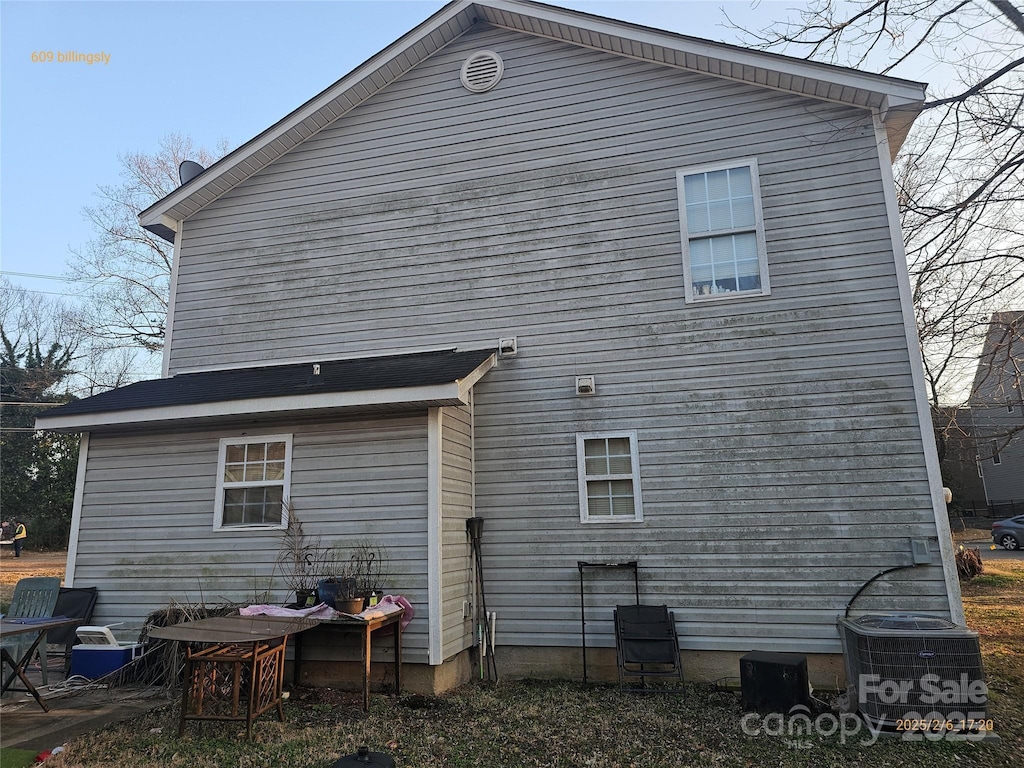 rear view of house featuring central AC unit