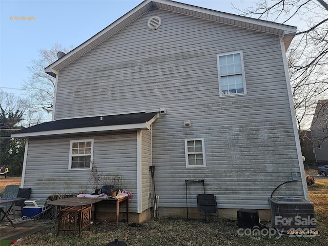 rear view of house featuring central AC unit