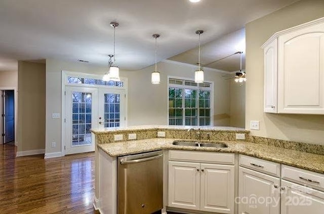 kitchen with sink, white cabinets, stainless steel dishwasher, kitchen peninsula, and light stone countertops