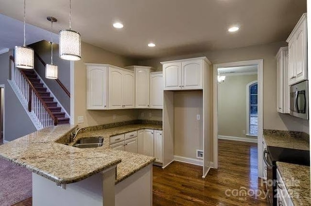 kitchen with sink, white cabinetry, black electric range, light stone countertops, and decorative light fixtures