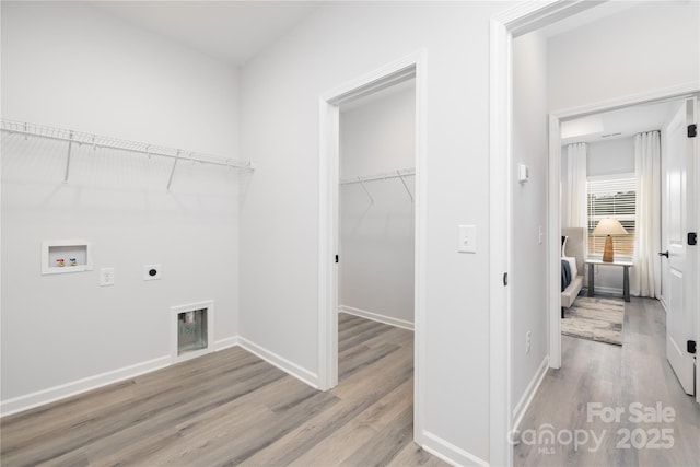 laundry area featuring wood finished floors, baseboards, hookup for an electric dryer, hookup for a washing machine, and laundry area