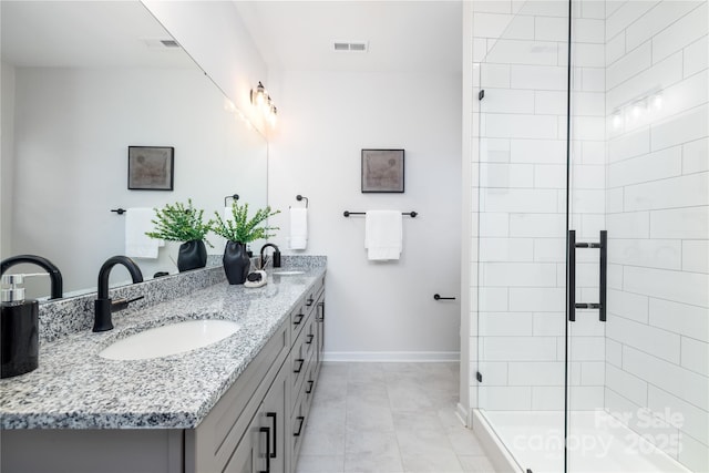 bathroom featuring a shower stall, visible vents, and a sink