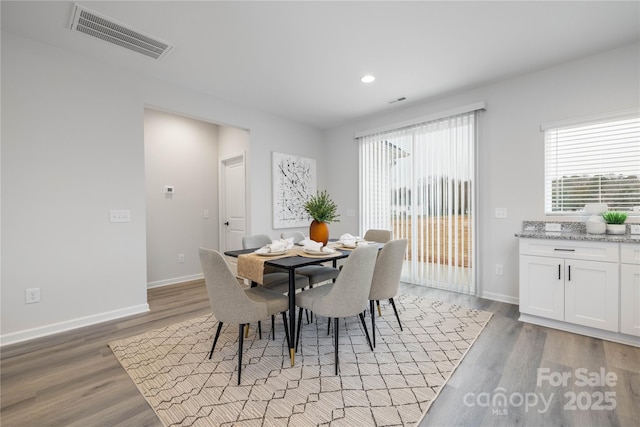 dining room with light wood-style flooring, recessed lighting, baseboards, and visible vents