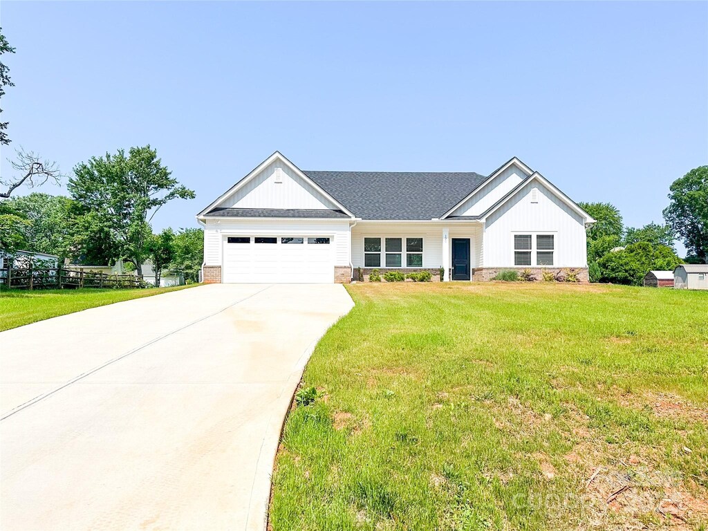 120 Random Dr, Salisbury, NC 28147 - view of front of property with a garage, concrete driveway, a front lawn, and brick siding