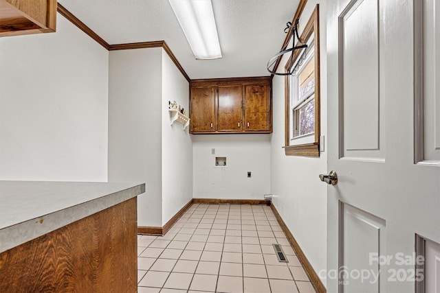 laundry room with light tile patterned floors, electric dryer hookup, cabinets, washer hookup, and ornamental molding