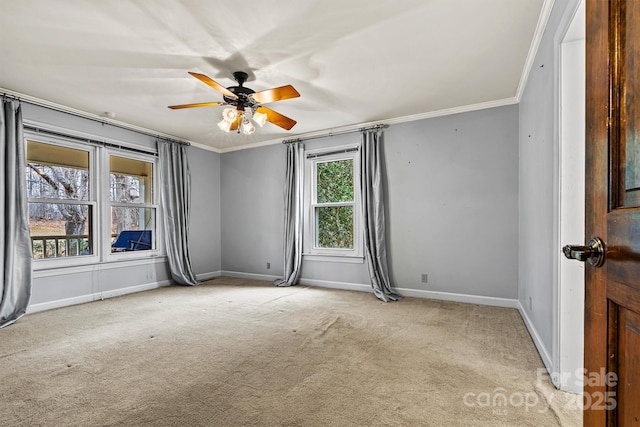 carpeted spare room featuring ornamental molding and ceiling fan