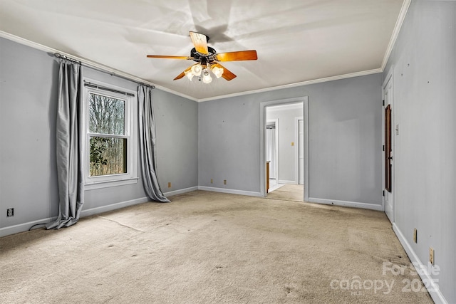 carpeted spare room with crown molding and ceiling fan