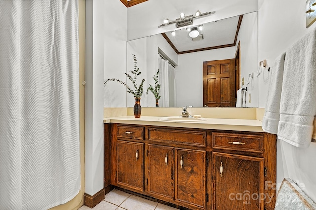 bathroom featuring tile patterned flooring, ornamental molding, and vanity