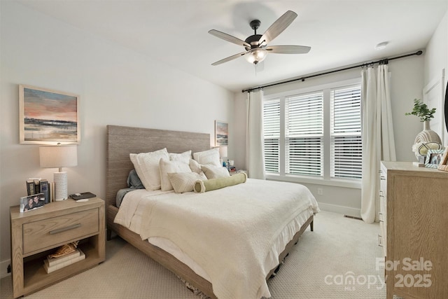 bedroom featuring light colored carpet and ceiling fan