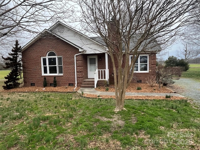 view of front of house with crawl space, brick siding, and a front lawn