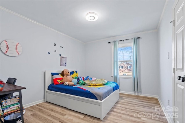 bedroom with crown molding and light hardwood / wood-style flooring