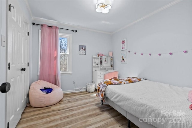 bedroom with crown molding, a closet, and light wood-type flooring