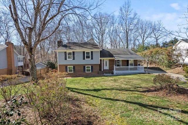 tri-level home with a front yard and covered porch