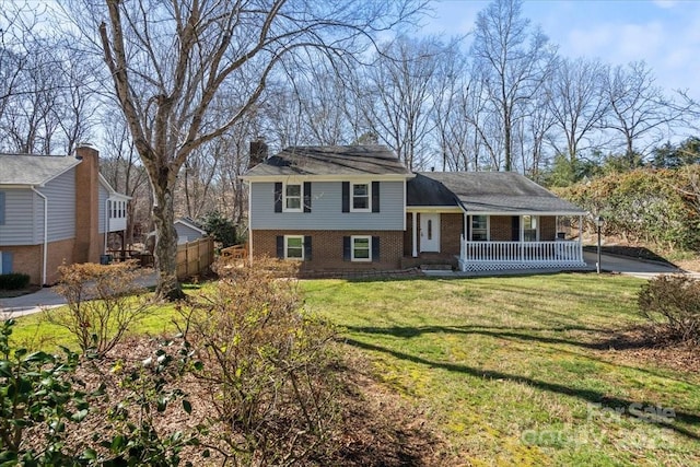 split level home with covered porch and a front yard