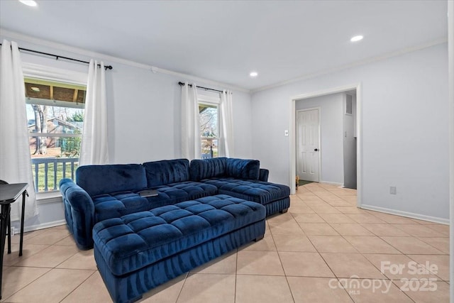 living room with light tile patterned floors, plenty of natural light, and ornamental molding