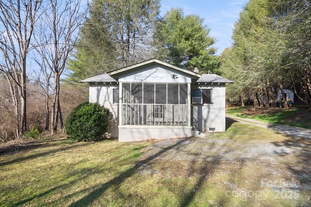 exterior space with a yard and a sunroom