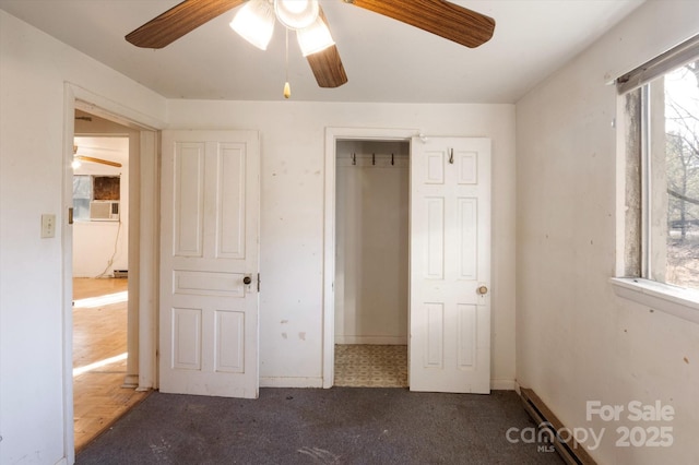 unfurnished bedroom featuring dark carpet and ceiling fan