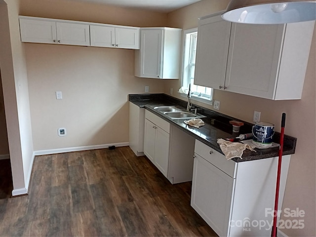 kitchen featuring white cabinetry, sink, and dark wood-type flooring