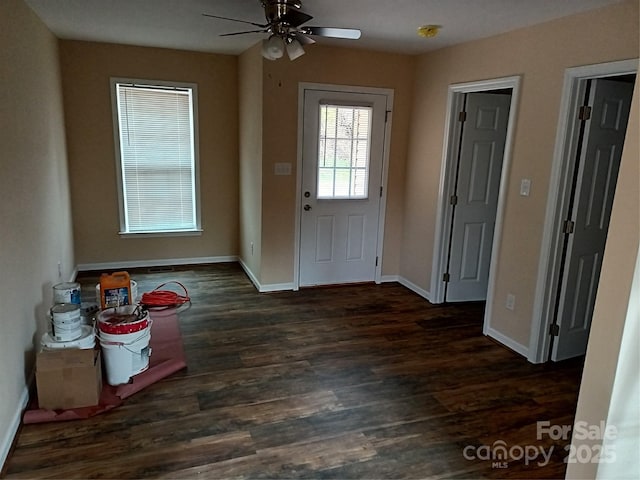 interior space with dark wood-type flooring and ceiling fan