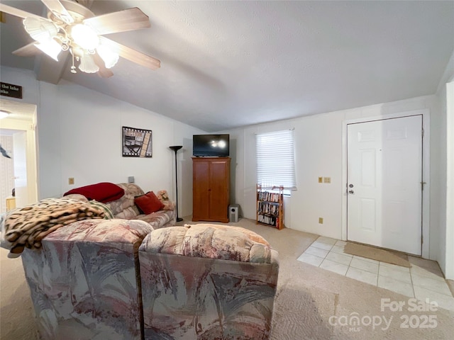 carpeted living room with ceiling fan and lofted ceiling